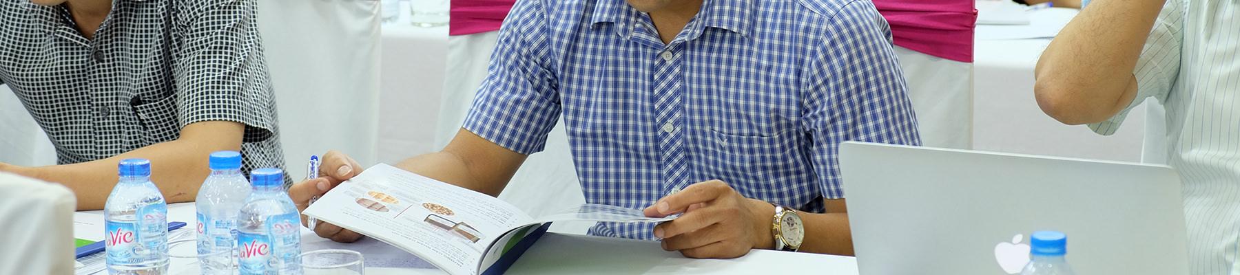 A Customs officer reviews the timber identification guide at a training workshop in Viet Nam