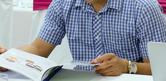 A Customs officer reviews the timber identification guide at a training workshop in Viet Nam